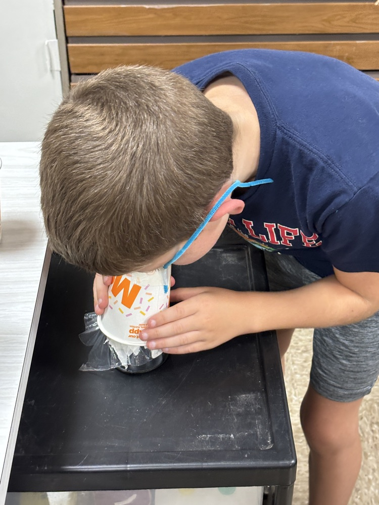 student smelling jar
