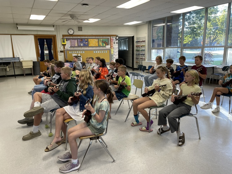 students playing ukuleles