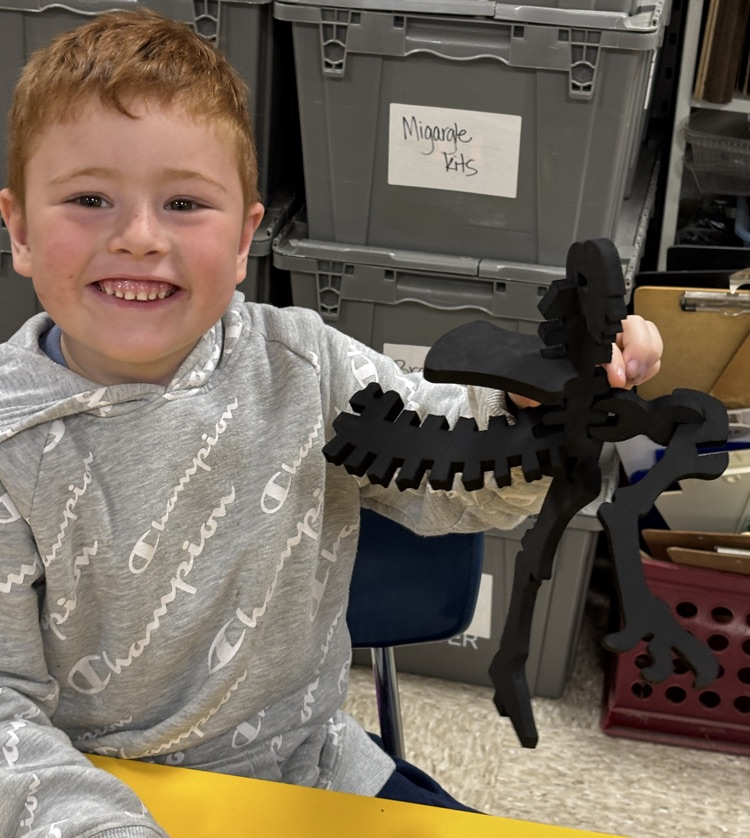 student with dinosaur