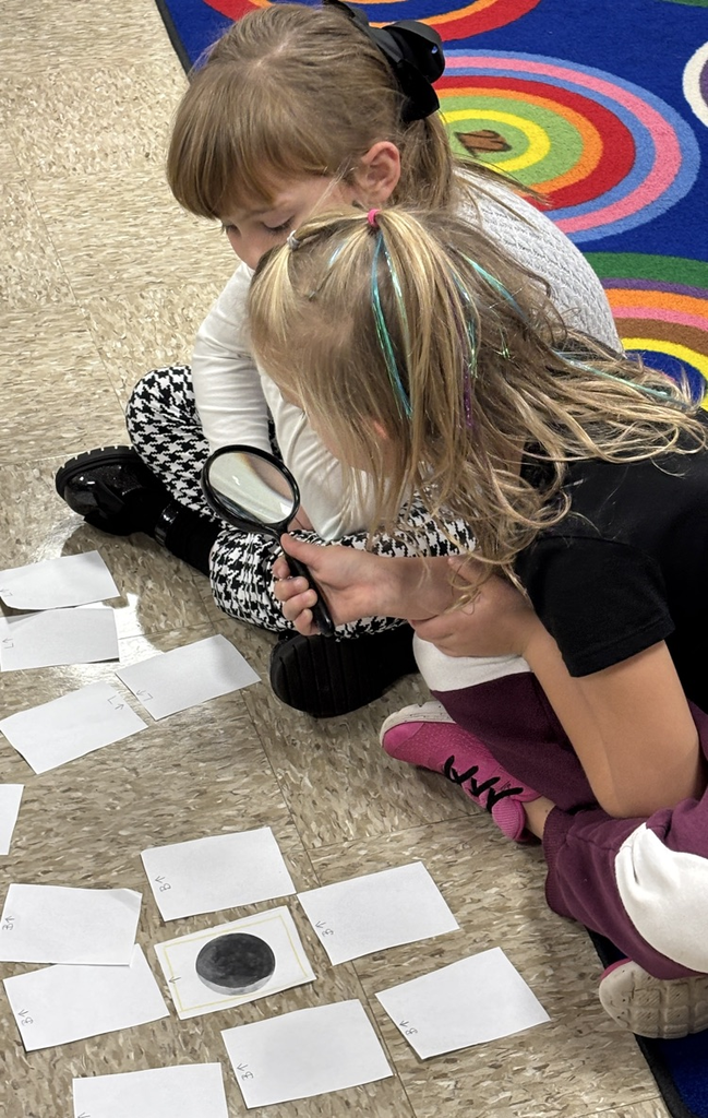 students with magnifying lenses