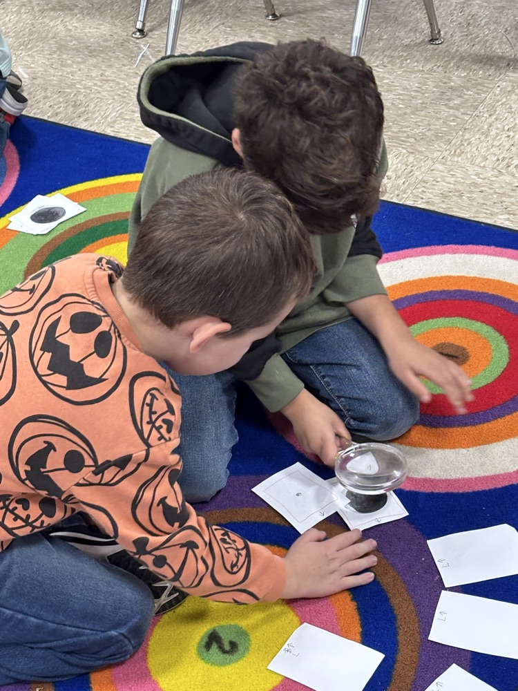 students with magnifying lenses