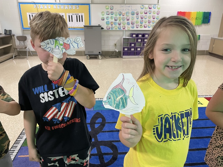 students standing with fish