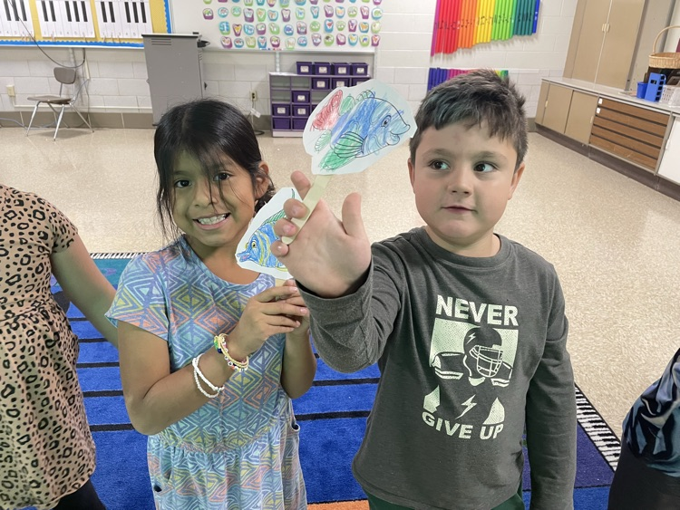 students standing with fish