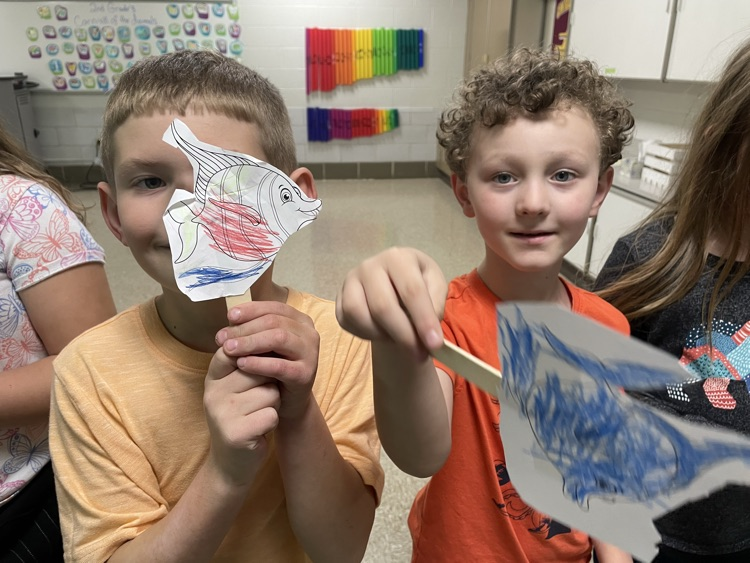 students standing with fish
