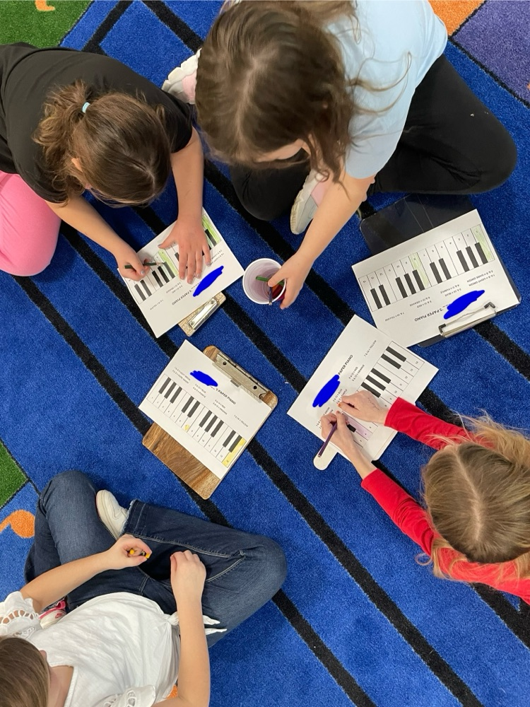 students coloring pianos
