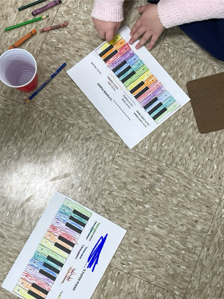 students coloring pianos