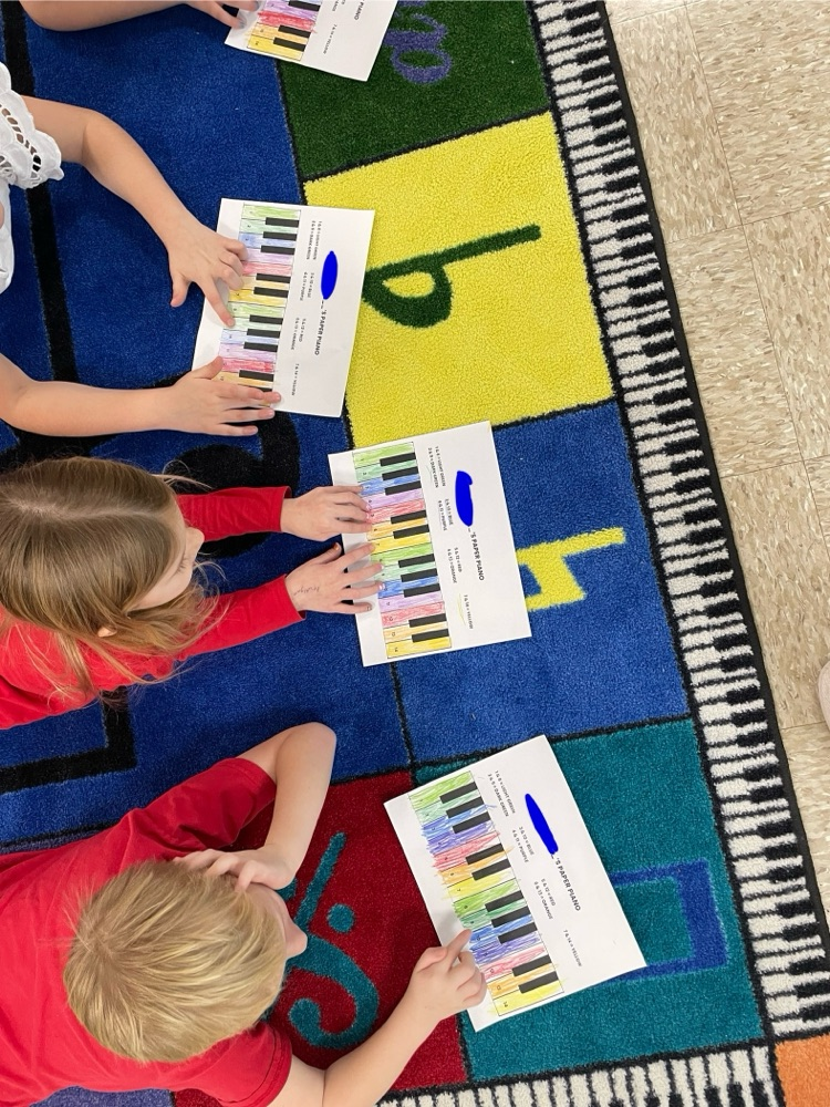 students playing pianos