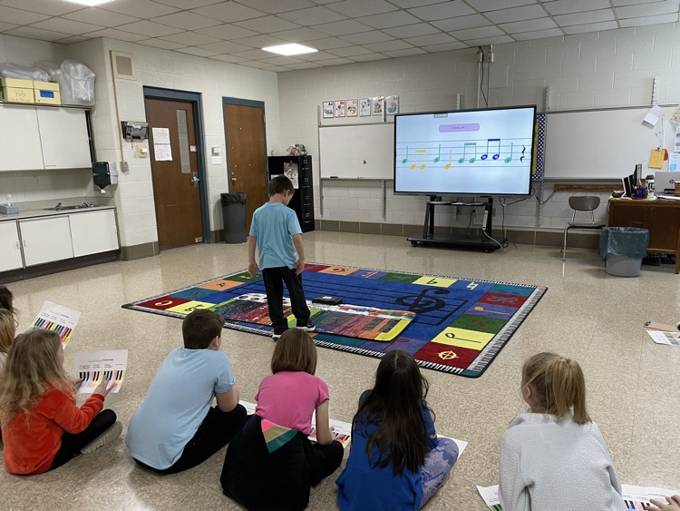 students playing pianos