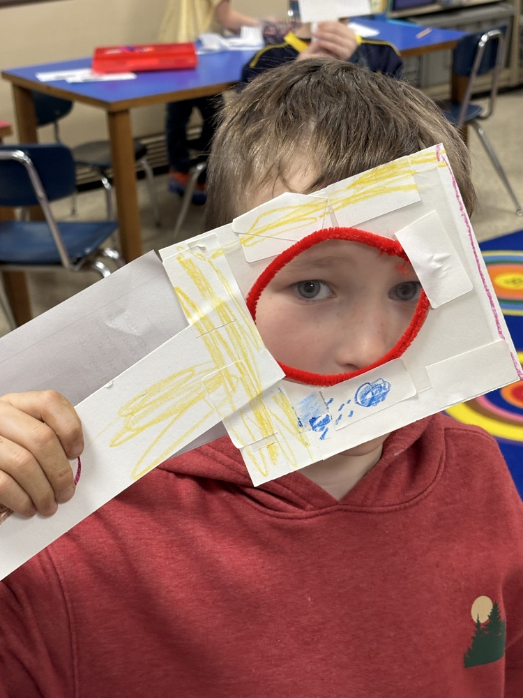 student with magnifying lens