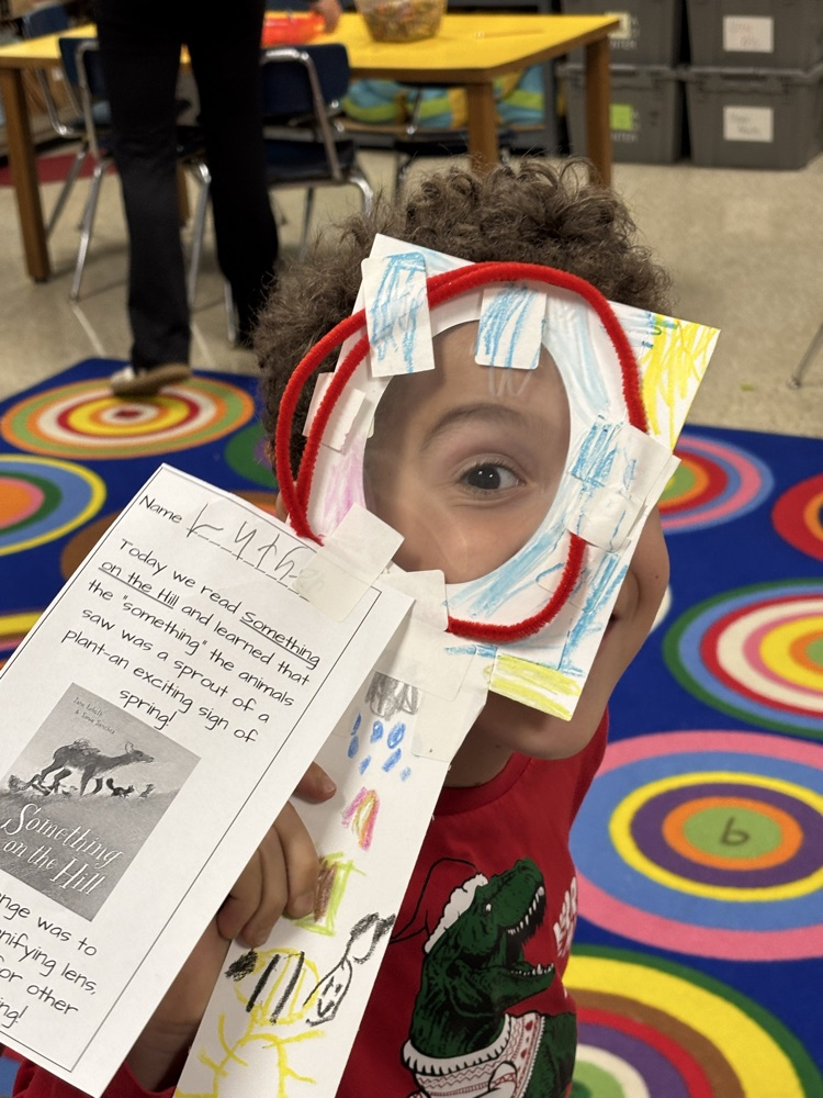 student with magnifying lens