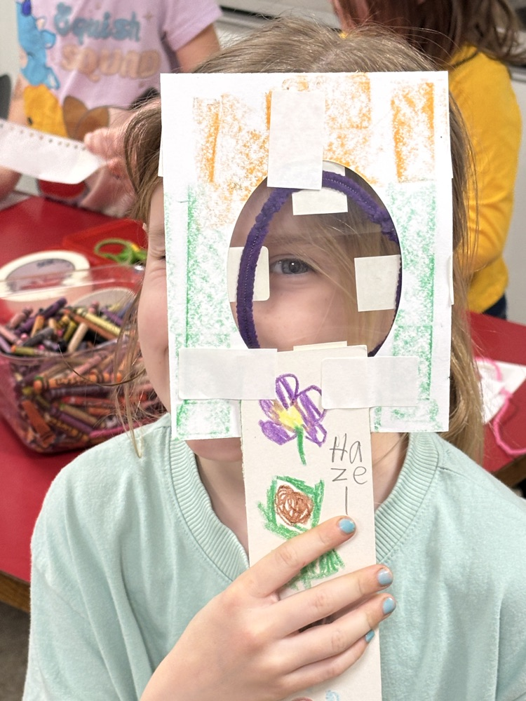 student with magnifying lens