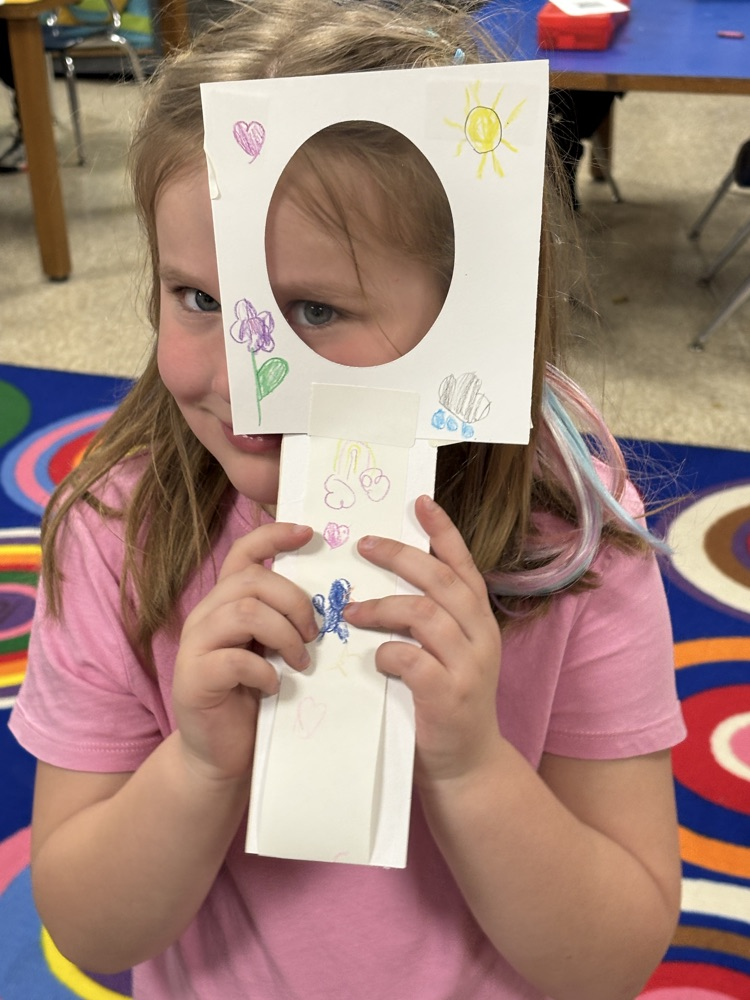 student with magnifying lens