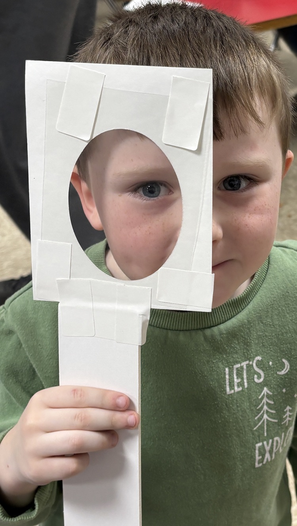 student with magnifying lens