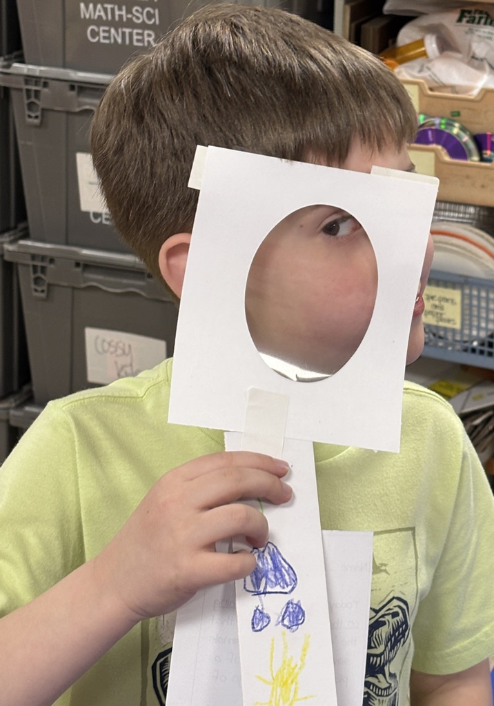 student with magnifying lens