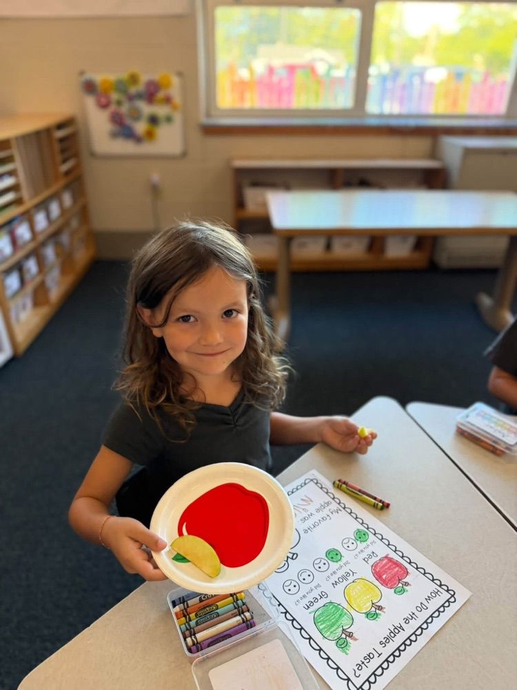 student with apple slice 