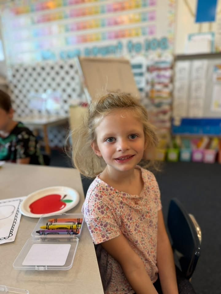 student with crayons 