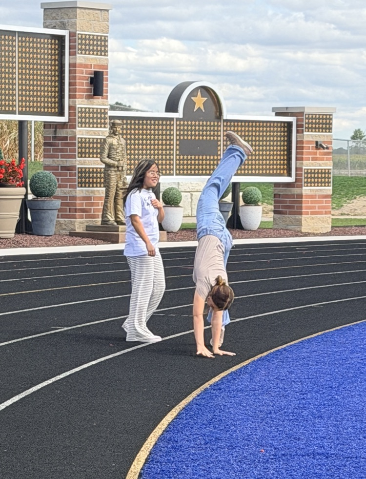 7th grade girl walking and girl doing cartwheel 