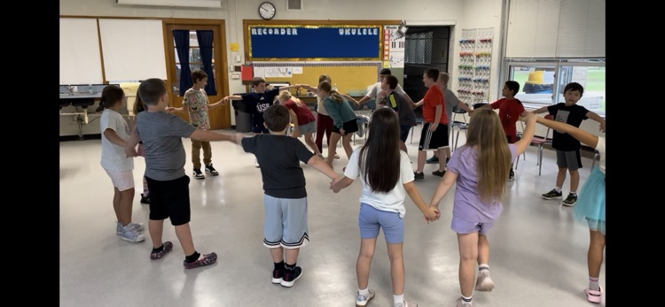 students holding hands in a circle 