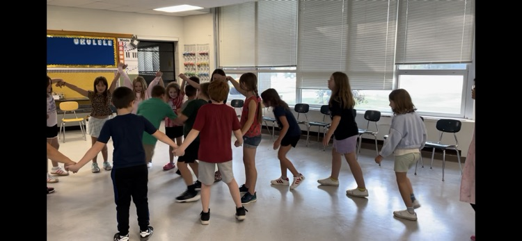 students holding hands in a circle 