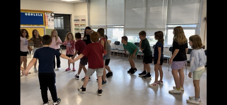 students holding hands in a circle 