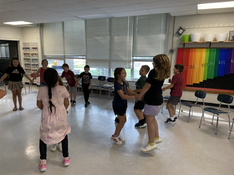 students holding hands in a circle 