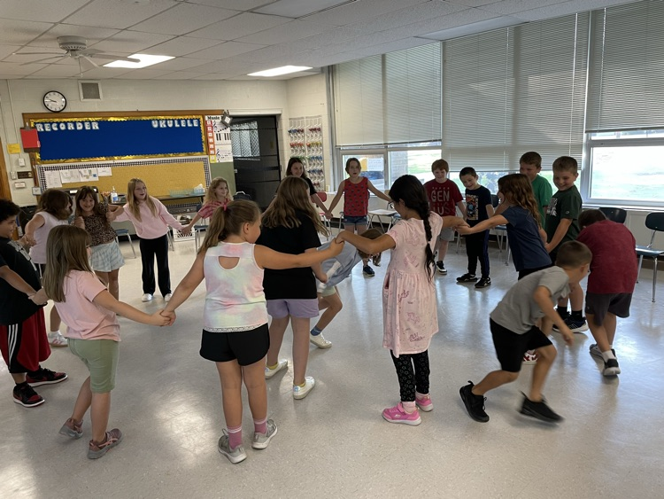 students holding hands in a circle 
