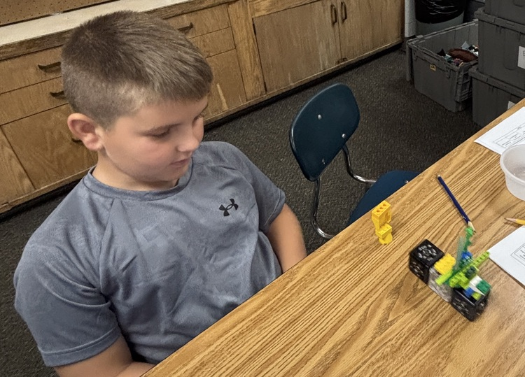 student with plant model 