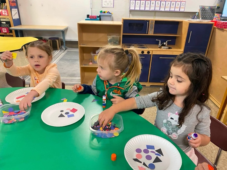 students with shapes and glue sticks