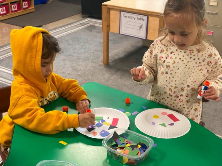 students with shapes and glue sticks