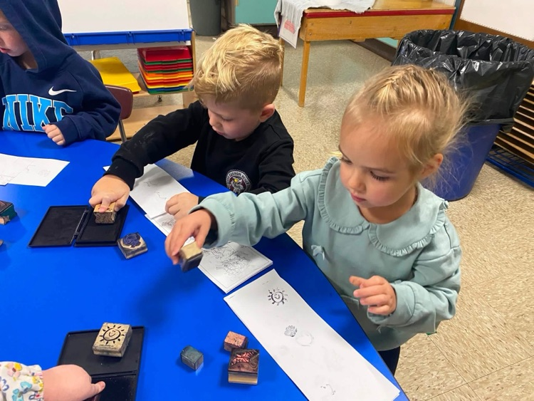 students with paper and stamps and ink pads