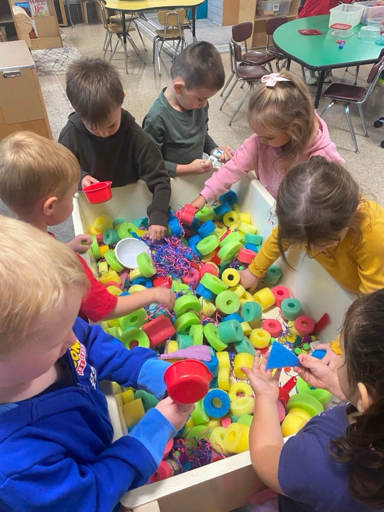 children playing in a sensory table