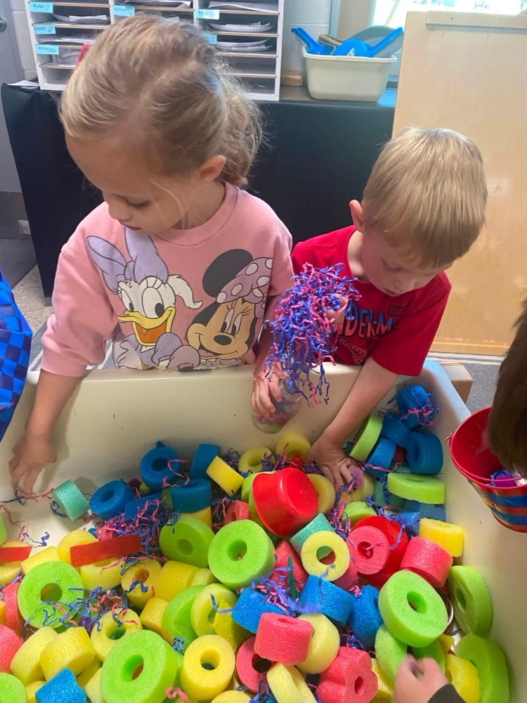 children playing in a sensory table