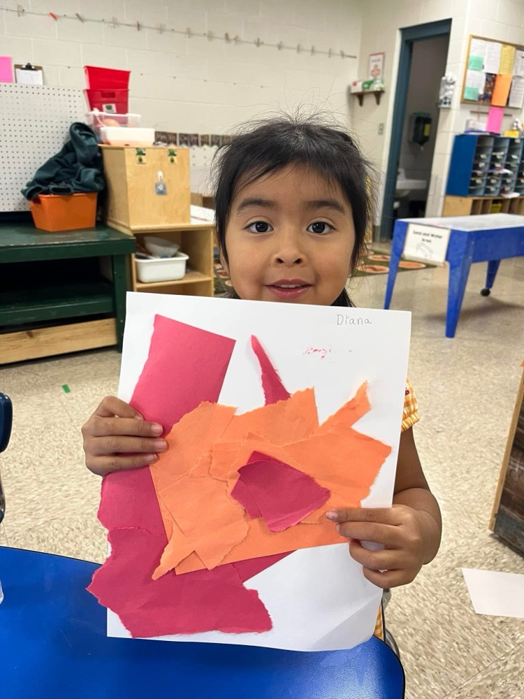 student holding their artwork
