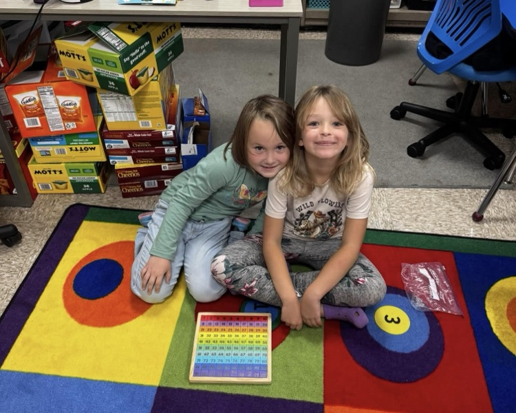 students on the rug with a puzzle