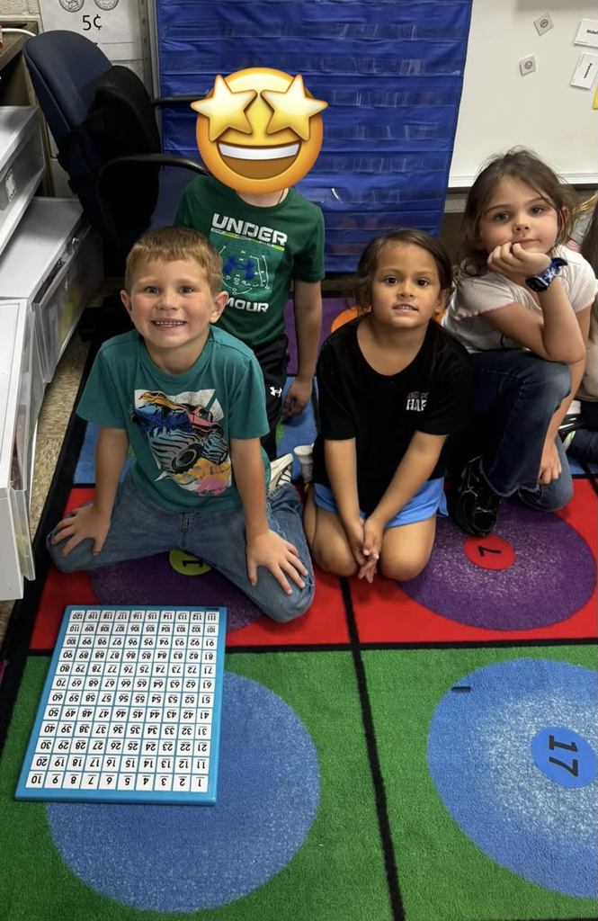 students on the rug with a puzzle