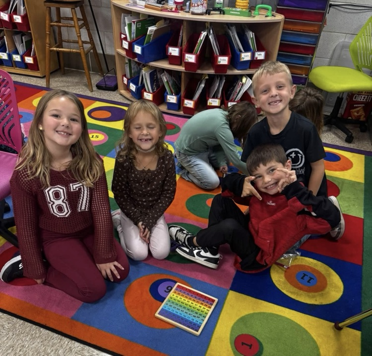 students sitting on a rug with their puzzle