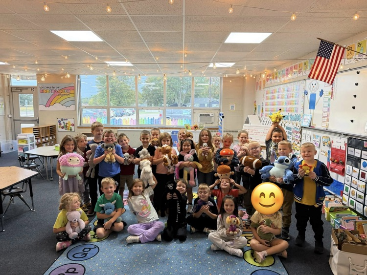 students in a class picture with their stuffies