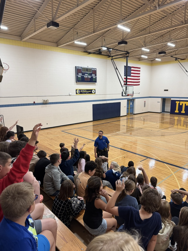 officer Greene presenting to 5th grade students in gym 