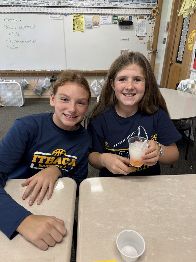 students holding cup in experiment 
