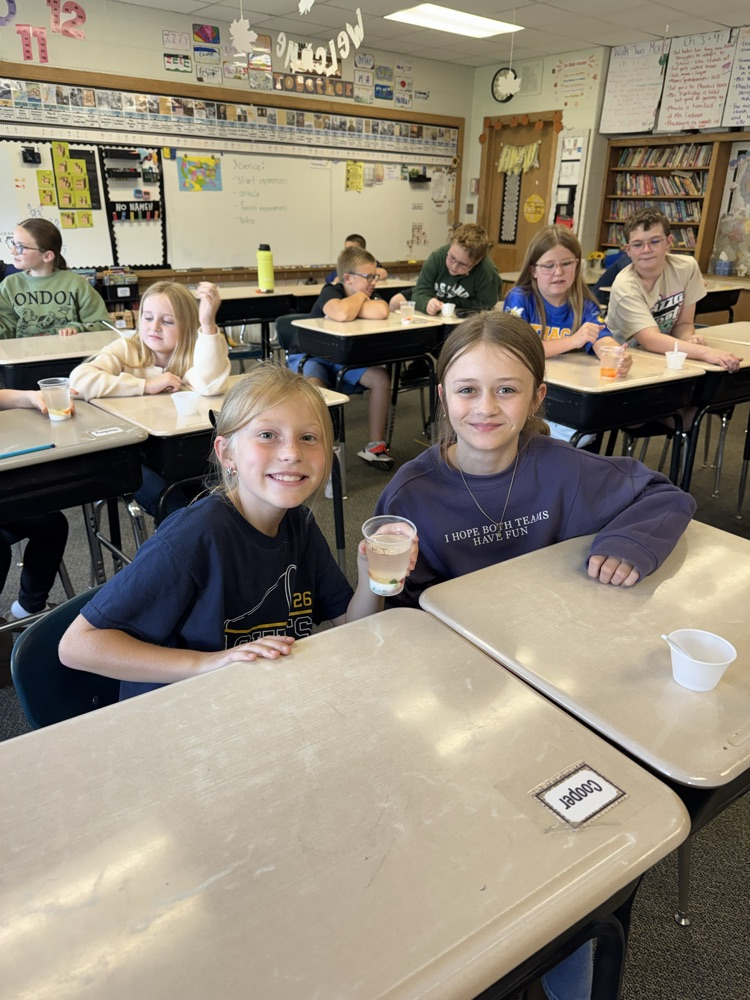 students smiling with science experiment 