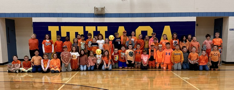 4th grade students dressed in their class color of orange