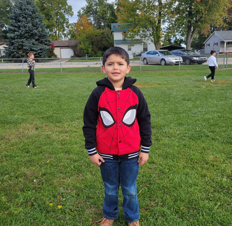 One student from North proudly supporting a graphic superhero coat/costume on the playground 
