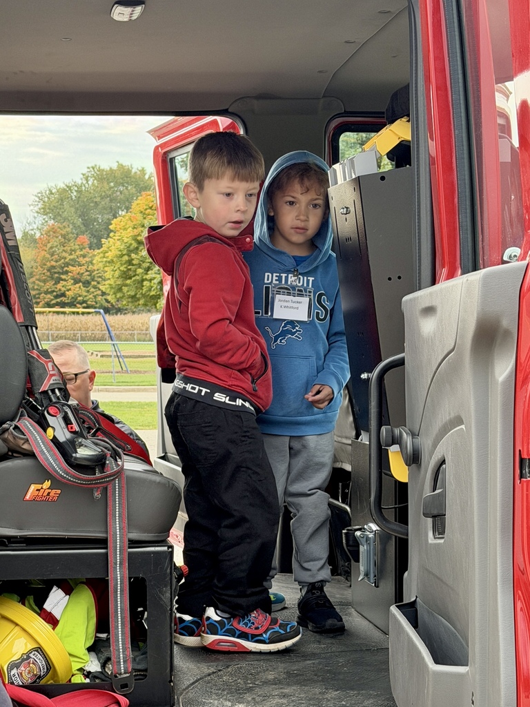 Students standing in a fire truck.