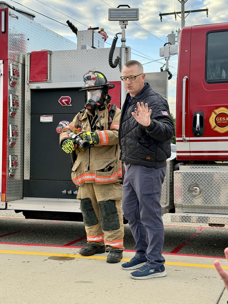 Firefighters talking to students.