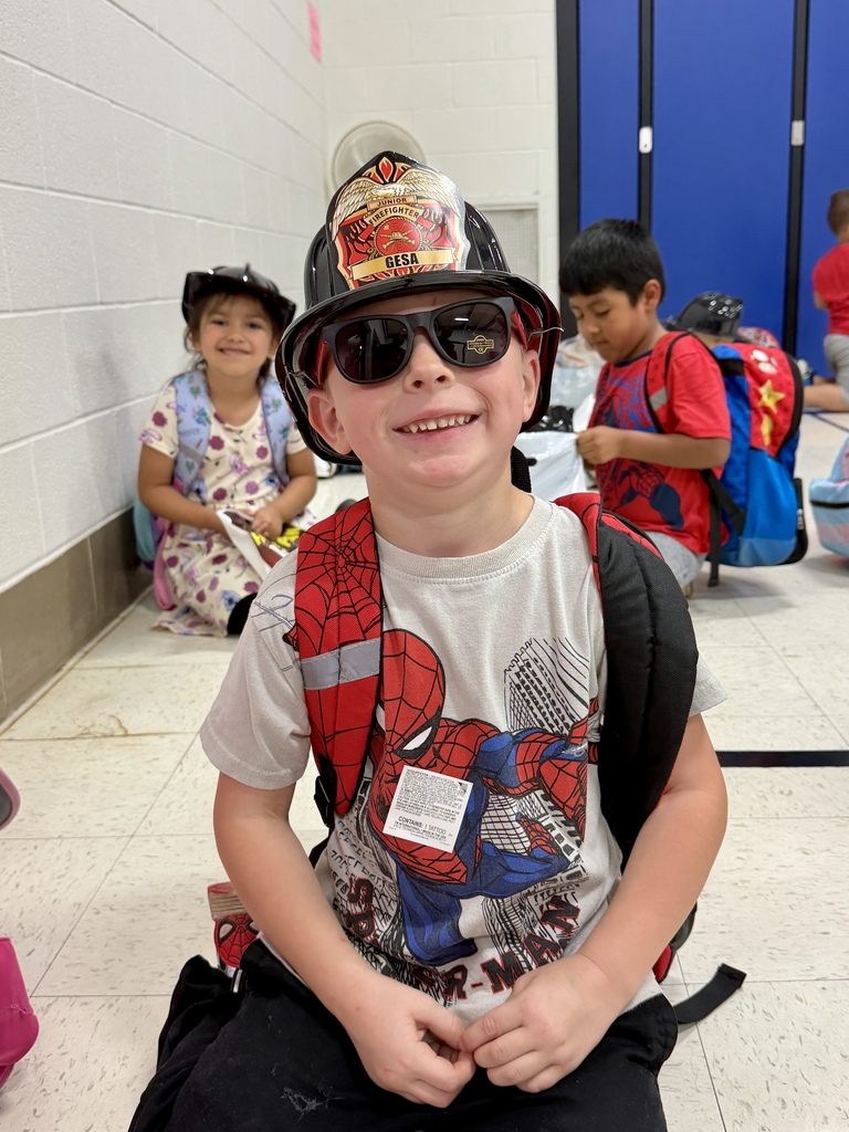Student wearing a firefighter helmet.