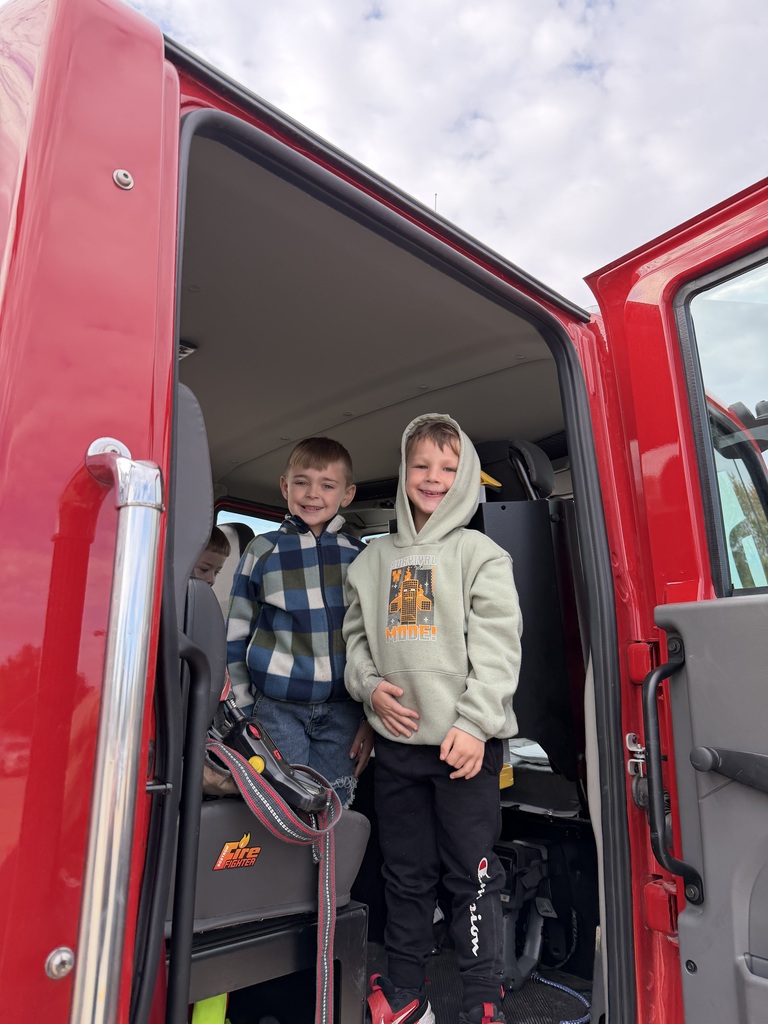 Students standing in a fire truck.