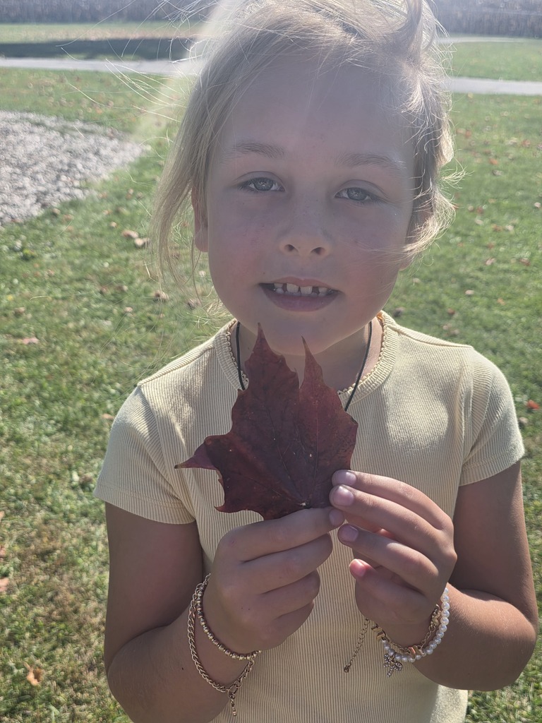Student holding a leaf.