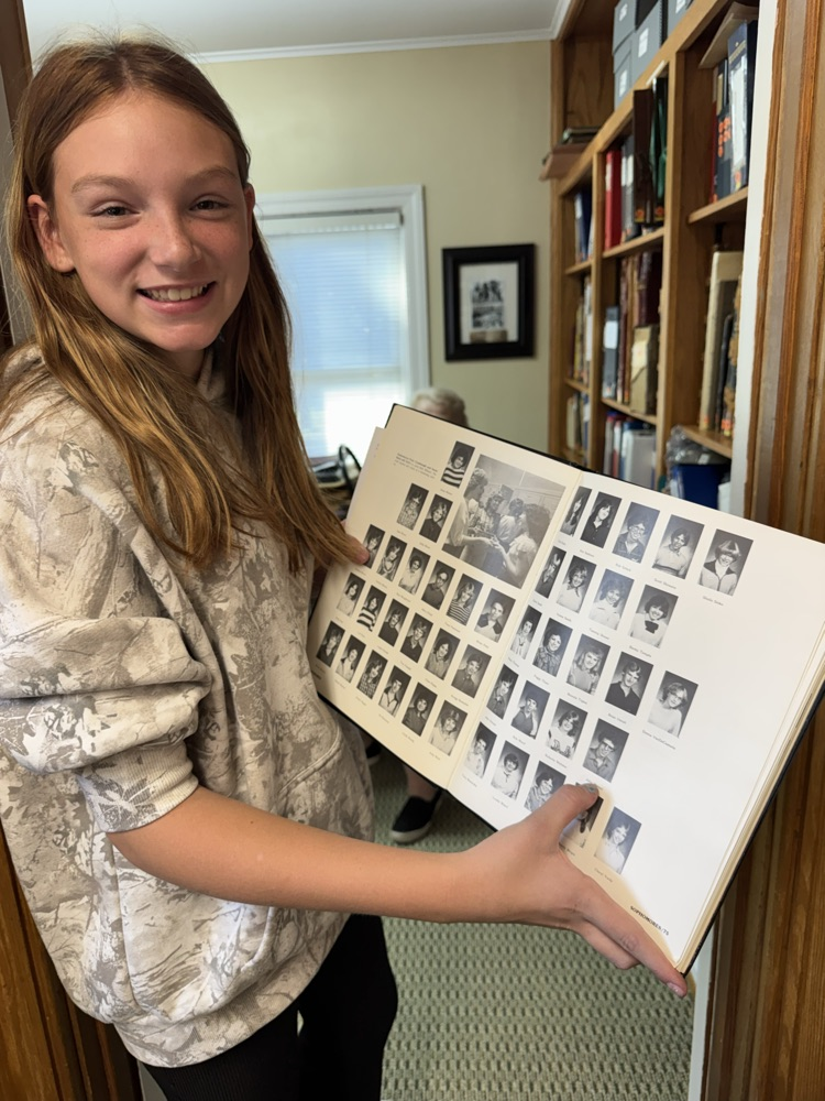 student holding book 