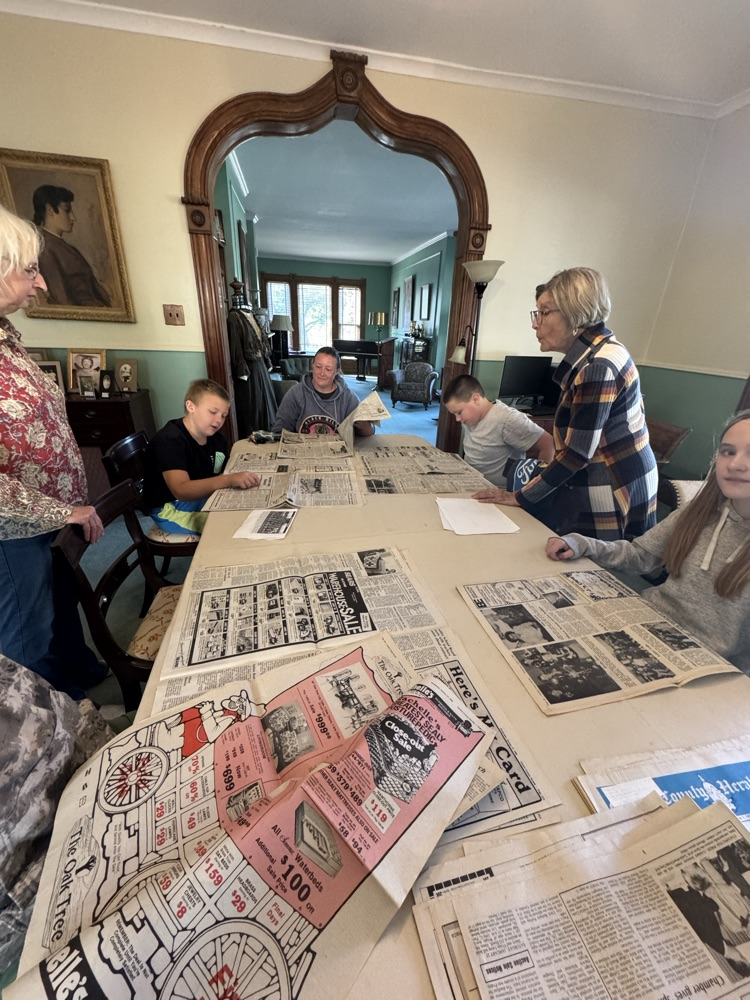 students looks through old newspapers 