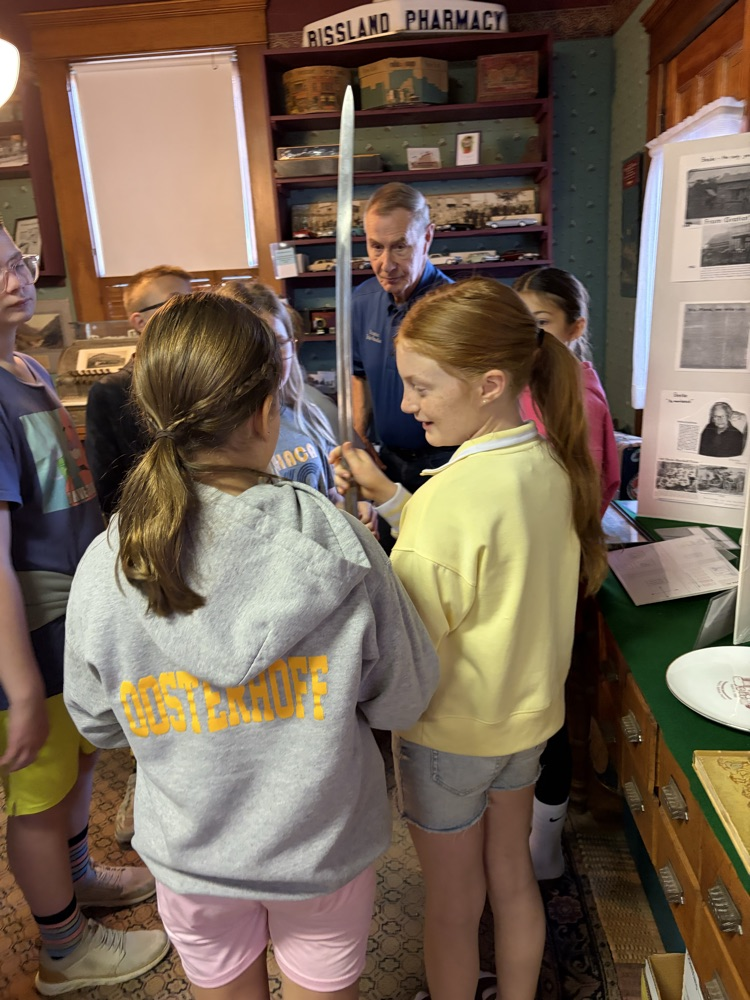 students looking at old civil war items 